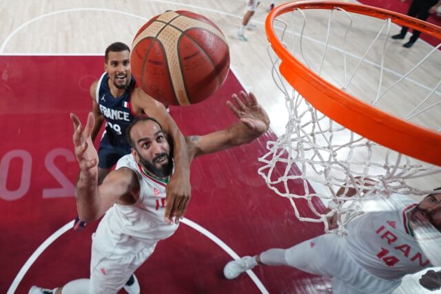 Hamed Haddadi (C) battling under the basket against France at the Tokyo Olympics