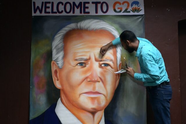 Indian artist Jagjot Singh Rubal gives final touches to an oil painting of US President Jo