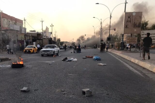 Iraqi protesters block a road following protests in the multi-ethnic Iraqi city of Kirkuk