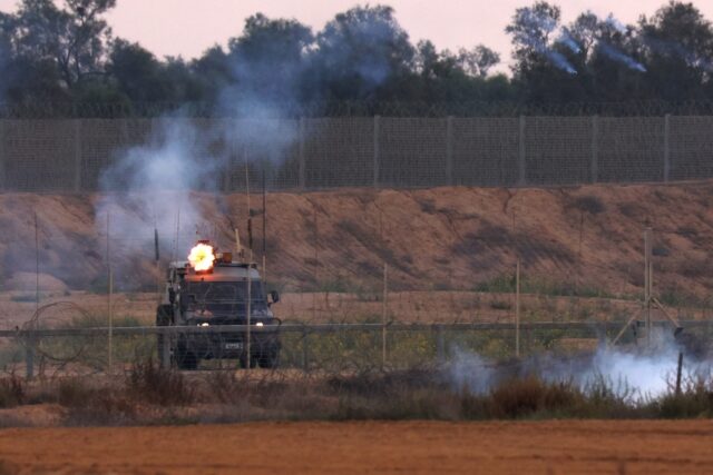 Israeli soldiers fire tear gas towards Palestinian protesters during clashes along the Gaz