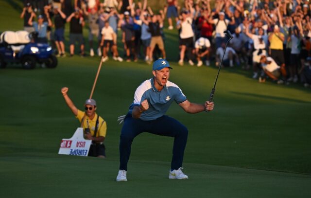 Justin Rose celebrates the putt which halved his fourball match at the Ryder Cup