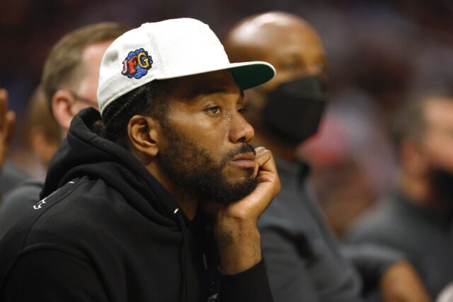 Kawhi Leonard of the Los Angeles Clippers watches an NBA game from the team bench but new