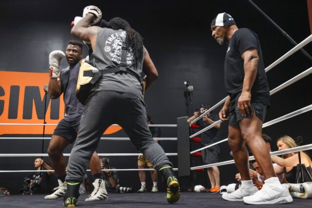 Mike Tyson (right) looks on as Francis Ngannou (left) trains for his upcoming heavyweight