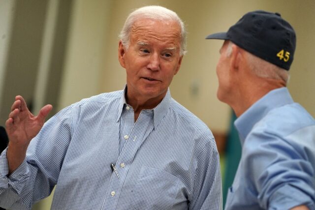 President Joe Biden talks to US Senator Rick Scott about recovery efforts from damage left