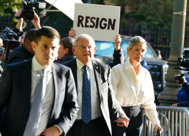 A protester outside a New York court calls on US Senator Bob Menendez to resign over corruption charges September 27, 2023