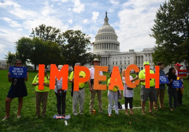 Protesters call for the impeachment of then-president Donald Trump in 2019 over his press