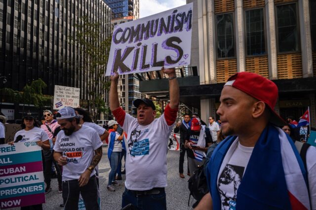 Protesters hold placards during a rally against Cuba's leadership near the United Nations