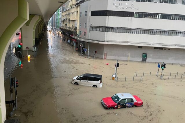 Record rainfall in Hong Kong caused widespread flooding Friday, disrupting road and rail t