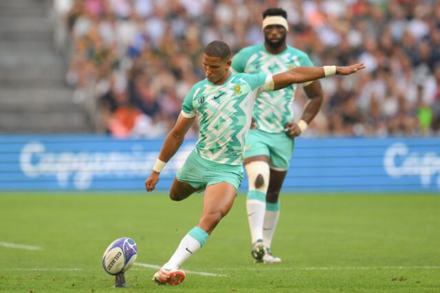 South Africa's flanker and captain Siya Kolisi (R) looks on as South Africa's fly-half Man