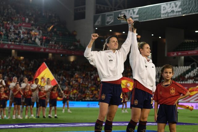 Spain captains Irene Paredes (L) and Alexia Putellas raise the Women's World Cup trophy in