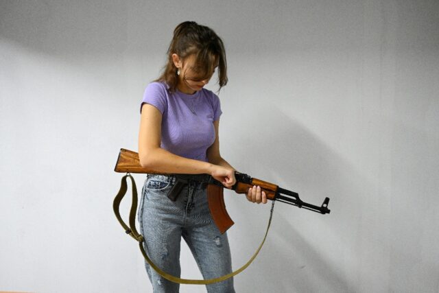 A Ukrainian schoolgirl learns to handle a Kalashnikov at a centre in Lviv, September 14
