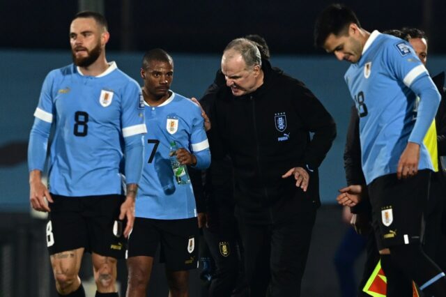 Uruguay's midfielder Nicolas De La Cruz (2-L) listens to his coach Argentine Marcelo Biels