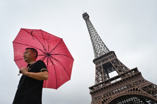 A man walks past a monument modelled on the Eiffel Tower in Hangzhou, host city of the Asi