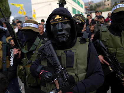 Palestinian militants take part in a military parade during a memorial ceremony commemorat