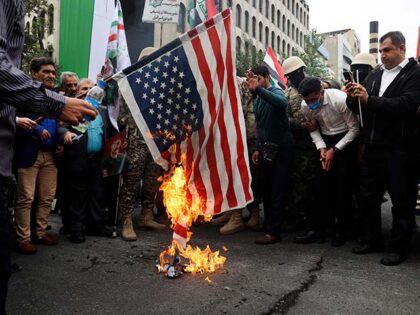 Iranian worshippers burn a U.S. flag during their pro-Palestinian rally before the Friday