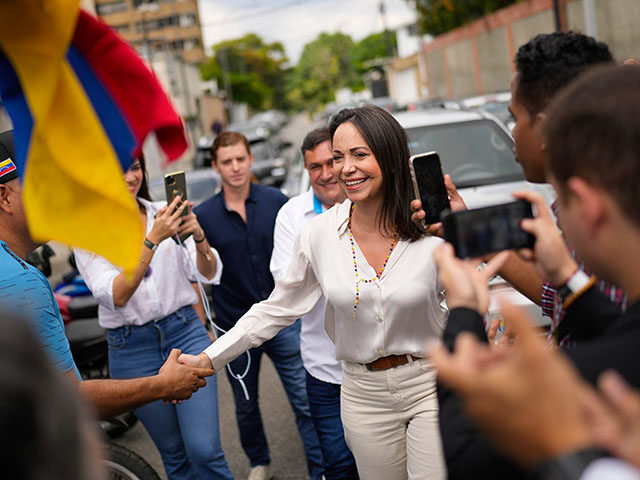 Supporters greet opposition presidential hopeful Maria Corina Machado as she arrives at a