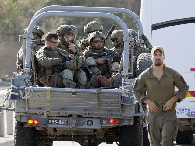 Israeli soldiers head south near Ashkelon, Israel on Oct. 7, 2023. Just three weeks into t