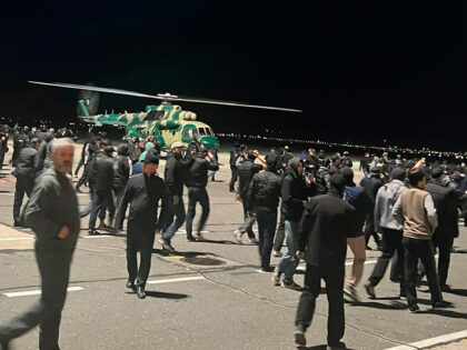 People in the crowd walk shouting antisemitic slogans at an airfield of the airport in Makhachkala, Russia, Monday, Oct. 30, 2023. Russian news agencies and social media say hundreds of people have stormed into the main airport in the Dagestan region and onto the landing field to protest the arrival …