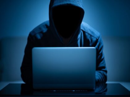 Anonymous hacker at laptop