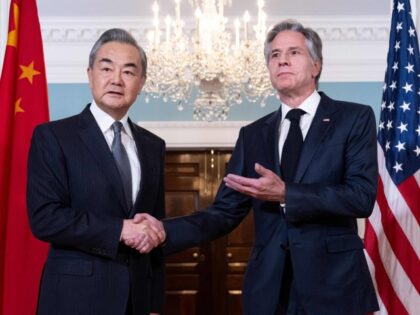 U.S. Secretary of State Antony Blinken shakes hands with Chinese Foreign Minister Wang Yi