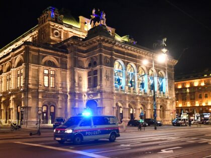 A police car drives in front of the opera house in the center of Vienna on November 2, 202