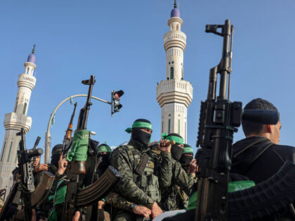 Members of the Ezzedine al-Qassam Brigades, the armed wing of the Palestinian Hamas movement, attend the funeral of their comrade Mohammed Abed during his funeral in Rafah in the southern Gaza Strip on February 16, 2022. - Mohammed Abed, 24, died after one of the tunnels used by the armed …