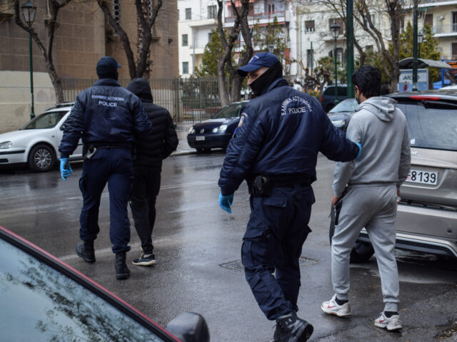 ATHENS, GREECE - 2022/03/20: Greek Police officers detain irregular migrants without legal