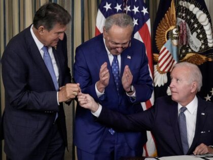 WASHINGTON, DC - AUGUST 16: U.S. President Joe Biden (R) gives Sen. Joe Manchin (D-WV) (L)