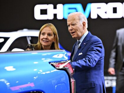 US President Joe Biden, with General Motors CEO Mary Barra, tours the Chevrolet exhibit at the 2022 North American International Auto Show at Huntington Place Convention Center in Detroit, Michigan on September 14, 2022. - Biden is visiting the auto show to highlight electric vehicle manufacturing. (Photo by MANDEL NGAN …