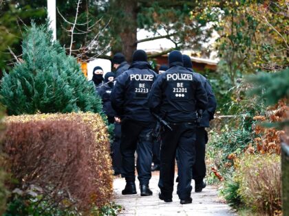 BERLIN, GERMANY - DECEMBER 07: Police walk to a residence that they raided earlier today o