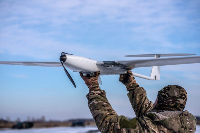 A soldier prepares to launch a Punisher Drone manufactured by UA Dynamics, which provides