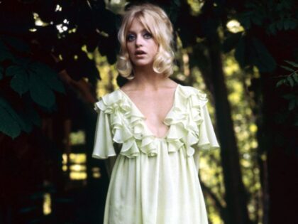 Full length portrait of Goldie Hawn, US actress, wearing a light green mini dress with a p