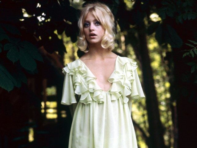 Full length portrait of Goldie Hawn, US actress, wearing a light green mini dress with a p