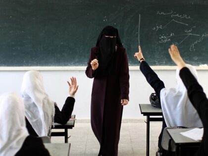 TOPSHOT - A Palestinian teacher speaks in class at a school in Gaza City on April 2, 2013.