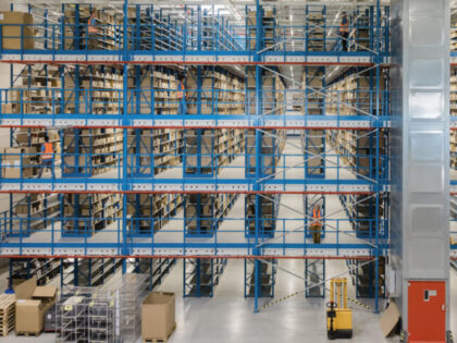 Interior of a modern shipping company. Large shelves and racks in distribution warehouse.