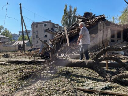 KHERSON, UKRAINE - SEPTEMBER 26: A person walks amid debris past a residential house destr