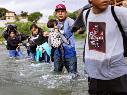 EAGLE PASS, TEXAS - SEPTEMBER 30: Immigrants from Venezuela cross the Rio Grande from Mexi