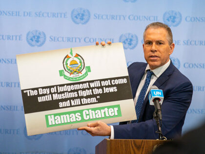 Israel's Ambassador to the U.N. Gilad Erdan holds up a sign as he speaks to reporters