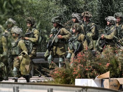 Israeli army soldiers stand at a checkpoint near the border with the Gaza Strip in Israel&