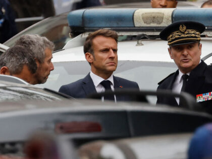French President Emmanuel Macron (C) arrives at the Gambetta high school in Arras, northeastern France on October 13, 2023, after a teacher was killed and two other people severely wounded in a knife attack, police and regional officials said. The perpetrator has been detained by police, Interior Minister Gerald Darmanin …