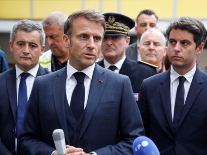 French President Emmanuel Macron (C), flanked by French Education and Youth Minister Gabriel Attal (R) and French Interior Minister Gerald Darmanin (L), talks to the press after a visit to the Gambetta high school in Arras, northeastern France on October 13, 2023, after a teacher was killed and two other …
