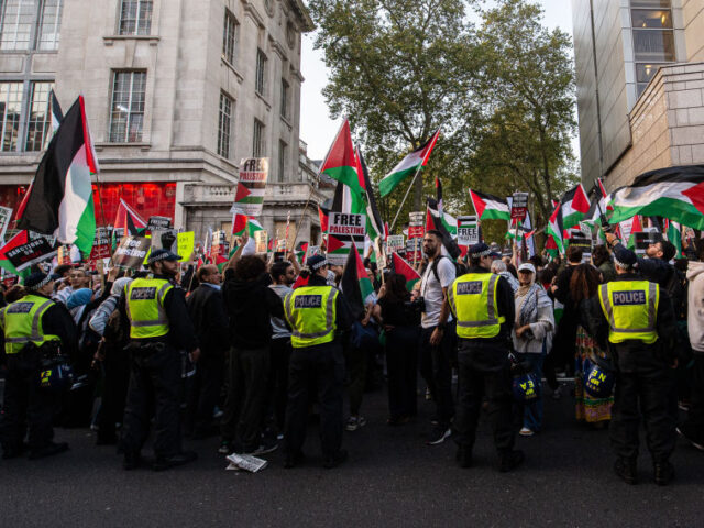 LONDON, ENGLAND - OCTOBER 9: Police maintain a large and visible presence as thousands of