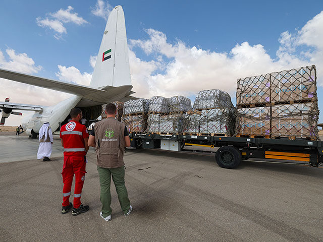 Staff members unload aid for the Palestinian Gaza Strip from an Emirates cargo plane on th