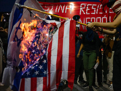 People burn the flags of Israel (L) and the US during a demonstration against Israel's military offensive in the Gaza Strip in Rio de Janeiro, Brazil, on October 19, 2023. Thousands of people, both Israeli and Palestinians have died since October 7, 2023, after Palestinian Hamas militants based in the …