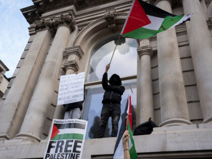 Protesters stand on the ledges of British government buildings in Whitehall as Pro-Palesti