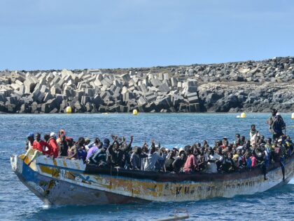 TOPSHOT - Migrants arrive on a boat at La Restinga dock, in the municipality of El Pinar on the Canary Island of El Hierro, on October 21, 2023. More than 1,300 African migrants have reached Spain's Canary Islands this weekend, with one vessel bringing a single-boat record of 321 people, …