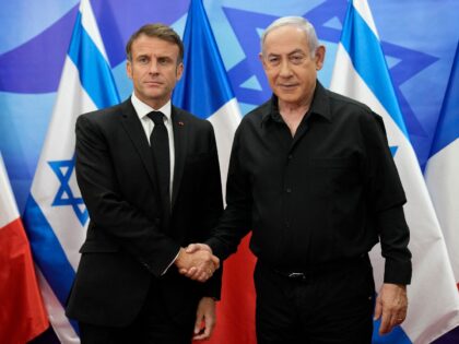 Israeli Prime Minister Benjamin Netanyahu (R) greets French President Emmanuel Macron before a meeting in Jerusalem on October 24, 2023. Macron's visit comes more than two weeks after Hamas militants stormed into Israel from the Gaza Strip and killed at least 1,400 people, according to Israeli officials while Israel continues …