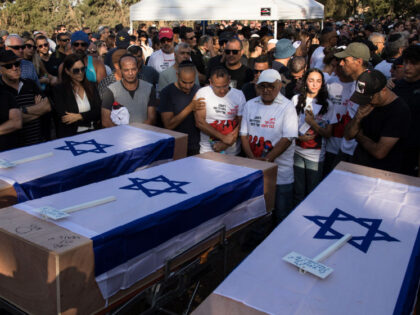 KFAR HARIF, ISRAEL - OCTOBER 25: Mourners attend the funeral for members of the Sharabi f