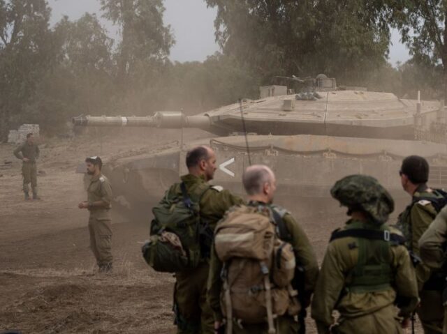 10/29/2023 Golan Heights, Israel. Soldiers see a tank passing by after battalion training