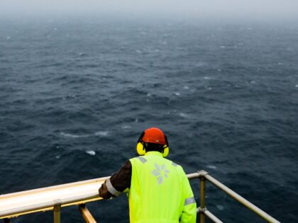 A rig worker looks out across the North Sea aboard the Troll A natural gas platform, opera